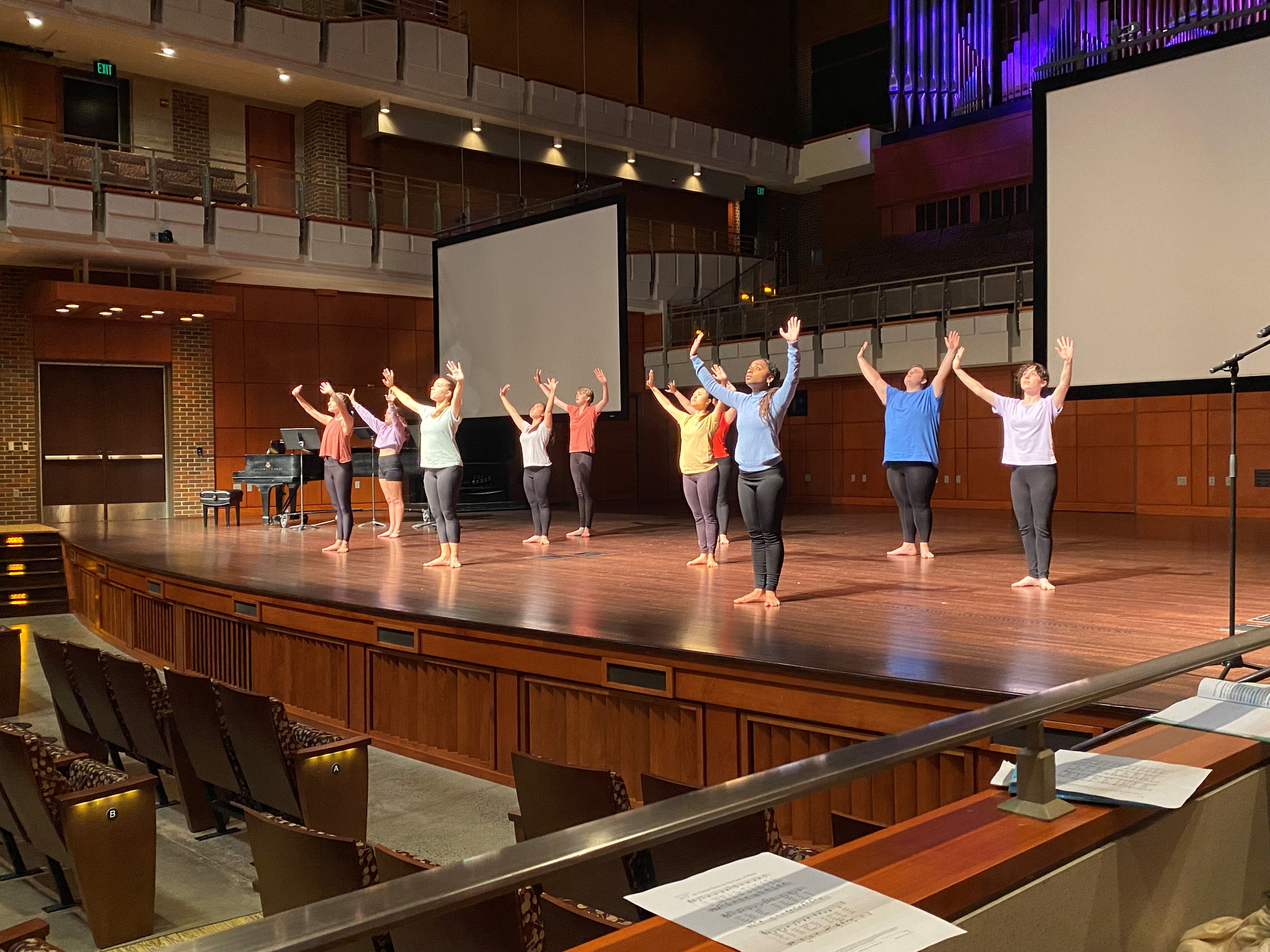 a picture of 10 dancers posing on stage while performing a dance for the international day of peace event 