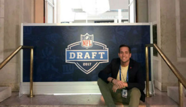 J. Parenti in front of NFL draft sign