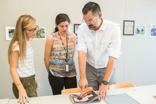 An art professor instructs two female students.