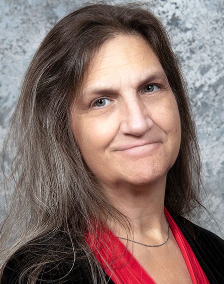 A headshot of an older woman with long hair.