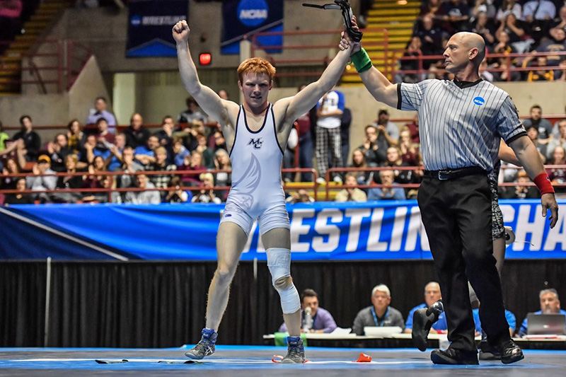 Lucas Malmberg standing victorious after his victory in NCAA division 3 national championship.