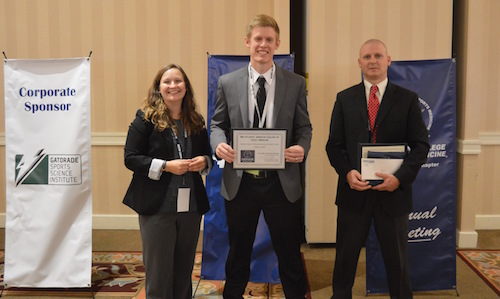 Noah Smith holding his American Physioloical Society'sDavid S. Bruce Excellence in Undergraduate Research Award at the 2015 Experimental Biology conference.