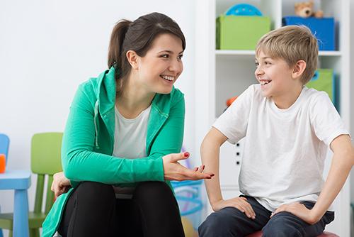 A teacher interacting with a child.