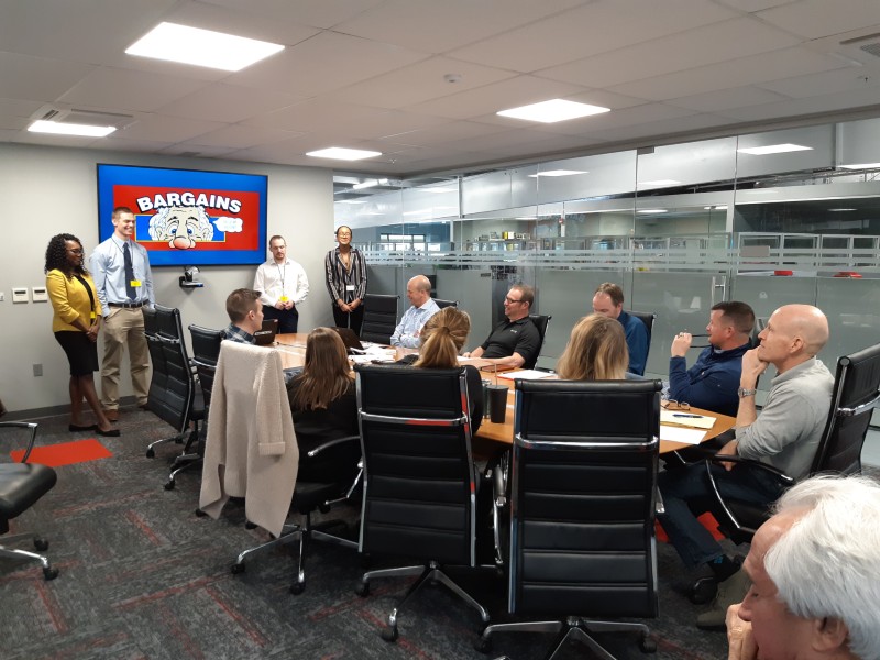 Messiah students present to Ollie's executive team in a glass boardroom