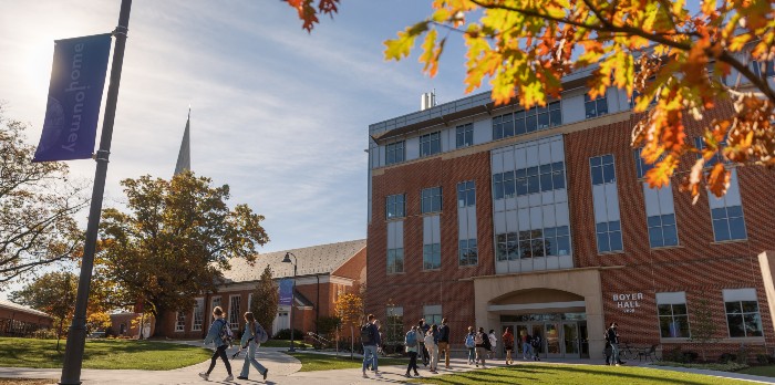 Students walk into a campus building.