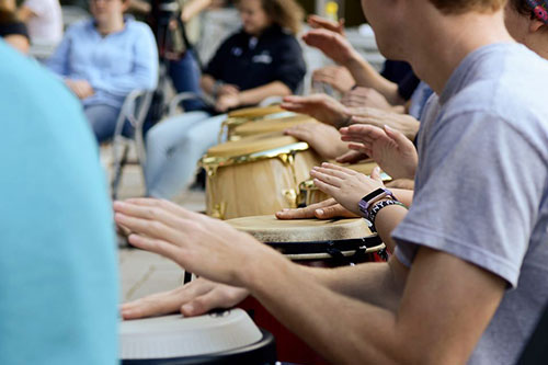 Messiah College student playing drums at Arts Invasion day