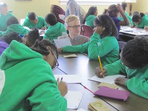 A Messiah University student works with students from the Harrisburg public schools to write poetry.