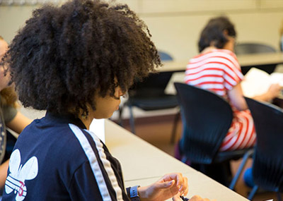 Student at desk, writing