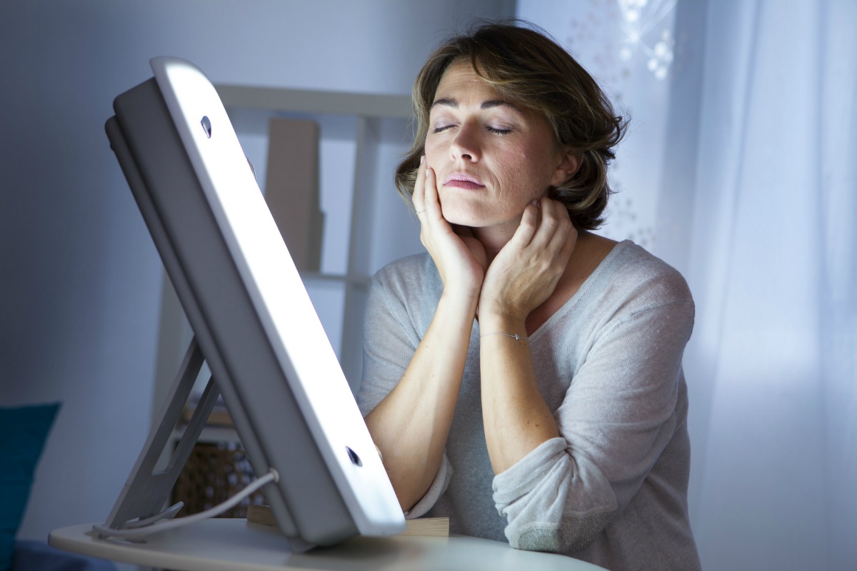 woman in front of light therapy