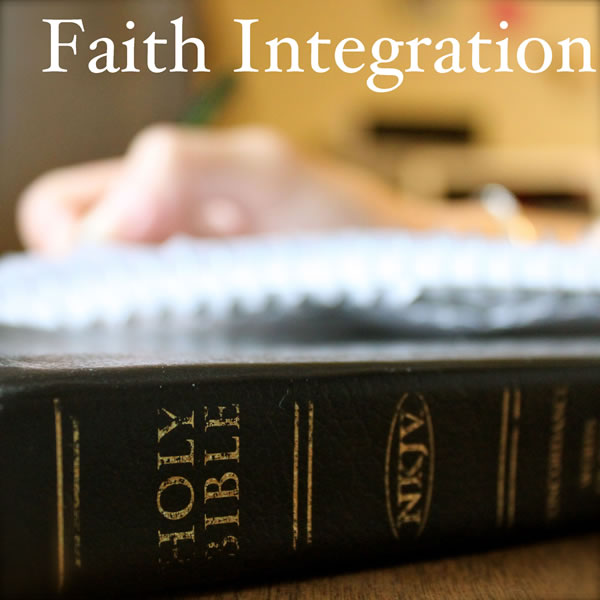 A hand resting on top of a notebook and a Bible.