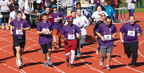 Disabled people running a race at the special olympics.