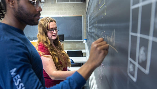 students at chalkboard