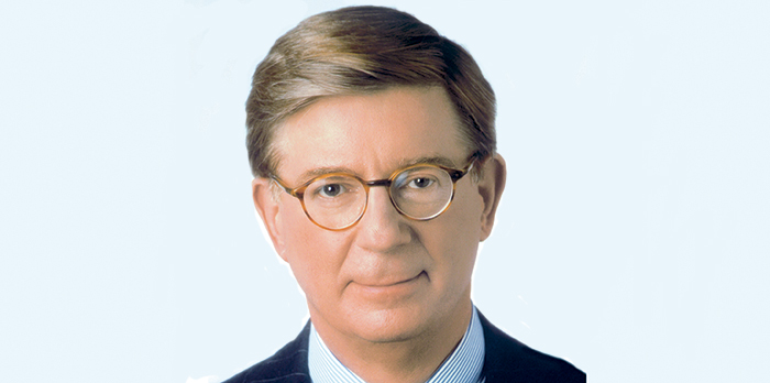 A headshot of a middle aged man with glasses