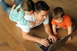 Student using computer with family