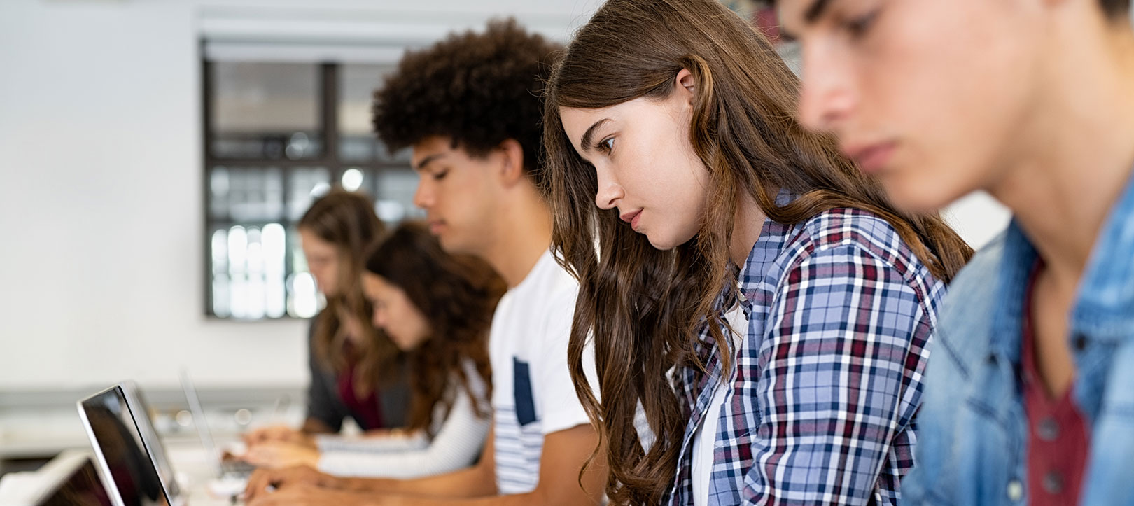 Students in classroom setting at laptops