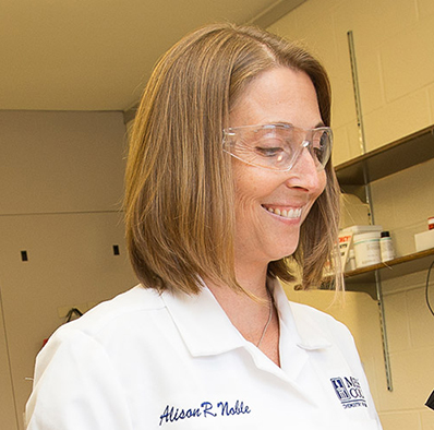 Alison Noble wearing a lab goggle in a chemistry lab.