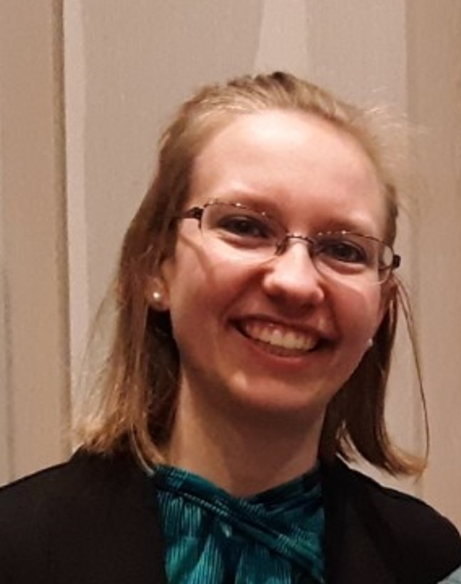 a close-up of a blonde female student wearing glasses