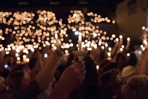 People holding up their candles during baccalaureate 2016