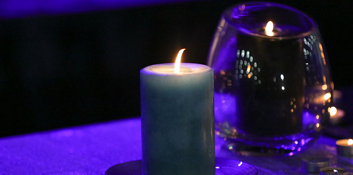 candle burning in a dark room