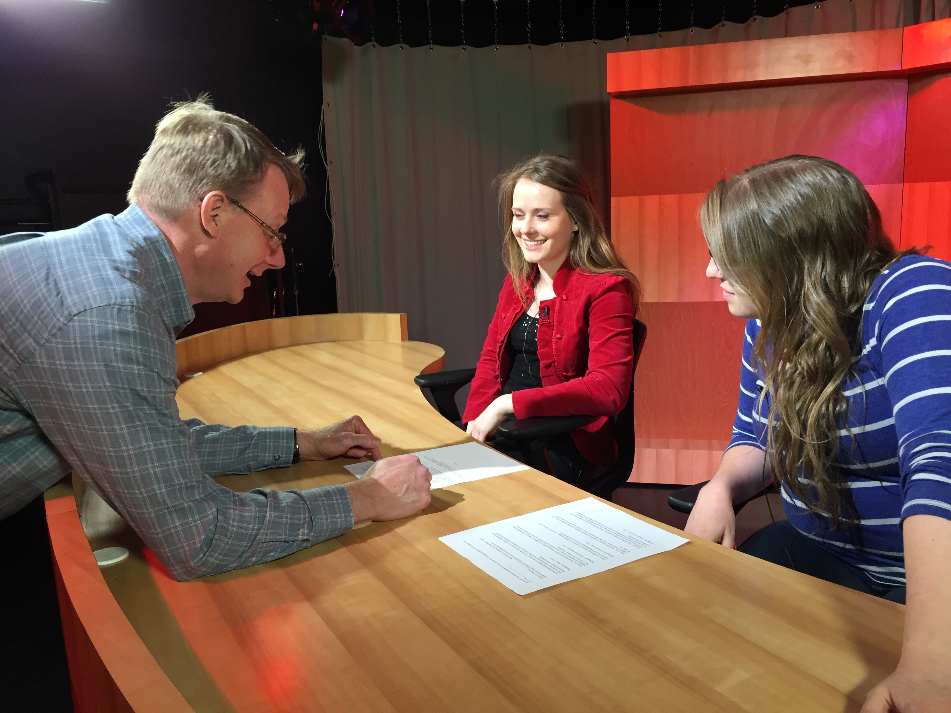 Students working in a studio, preparing for a TV show.