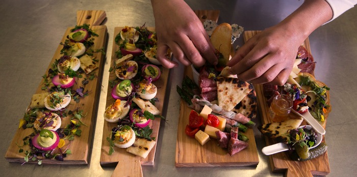 Deviled eggs, meats, cheeses on a Charcuterie board.