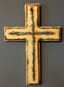 A cross made of gold and barbed wire is shown on a solid background.