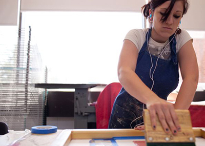 An art student working on her screen printing project