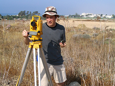 David Pettegrew looking through a theodolite