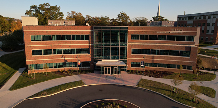 The Welcome Center sits in front of a traffic circle on a sunny day.