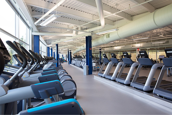 Treadmills and ellipticals line the walls of the Falcon Fitness Center.