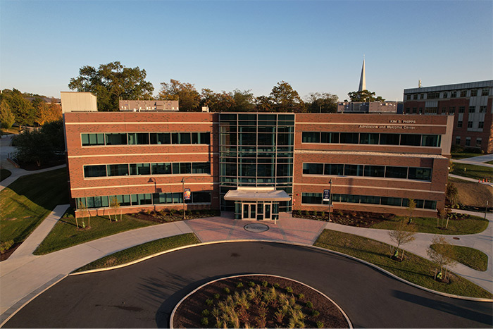 The Welcome Center sits in front of a traffic circle on a sunny day.