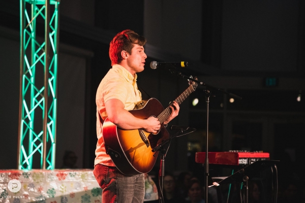 A student performing an original song.