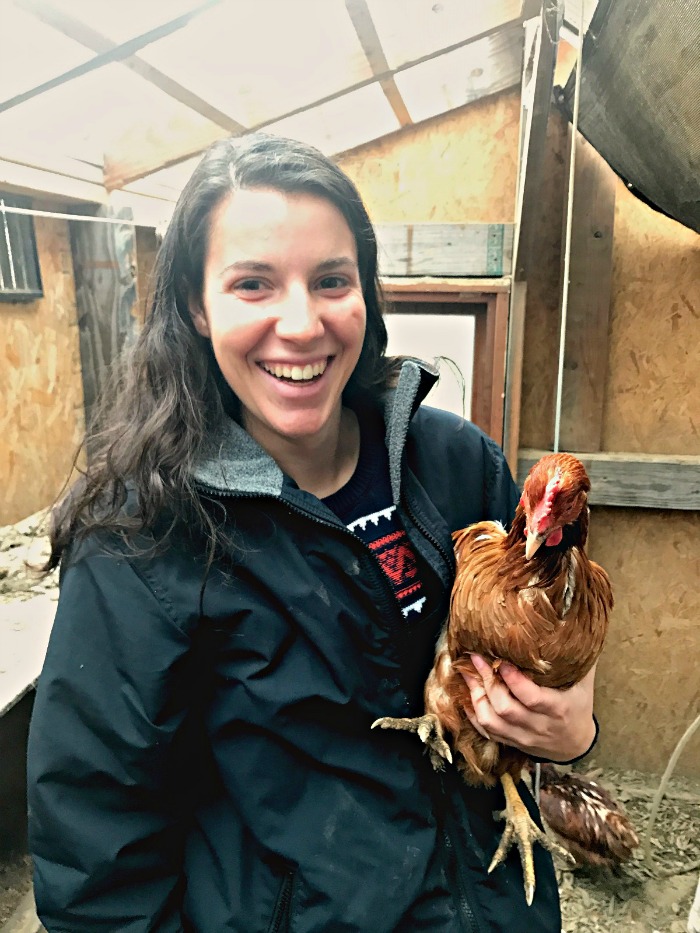 Olivia Mingora holding a chicken.
