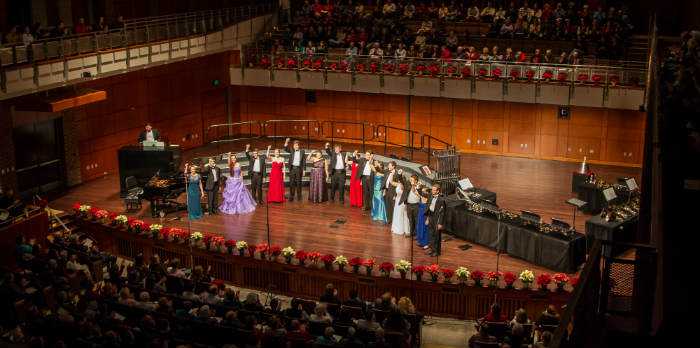 Students singing on stage in the High Center