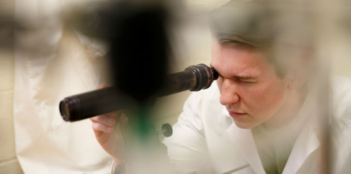 Student looking at microscope