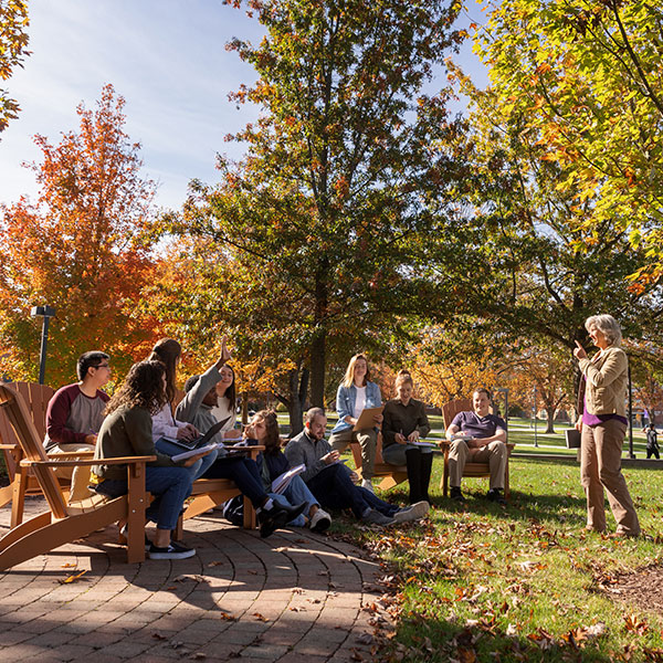 Students and professor in class outside