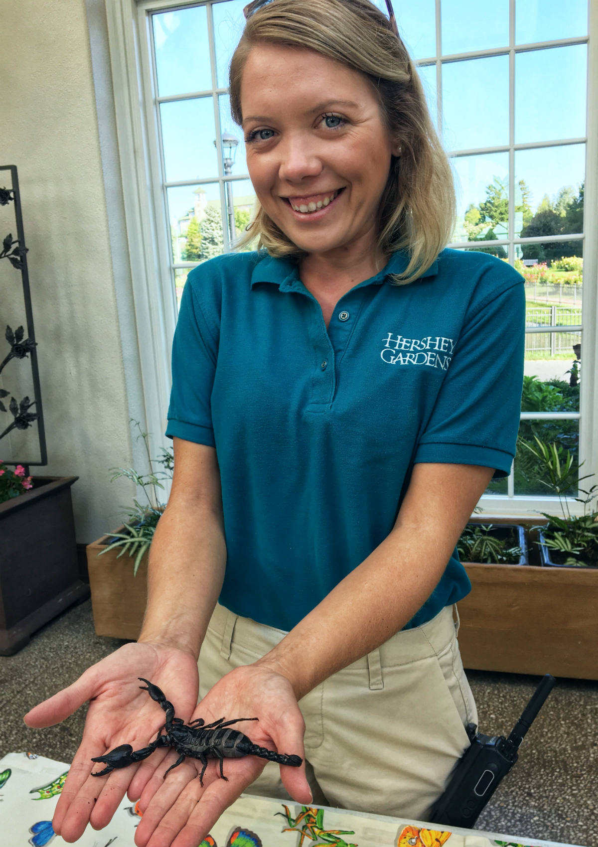 Megan Talley holding a scorpion at Hershey Gardens.