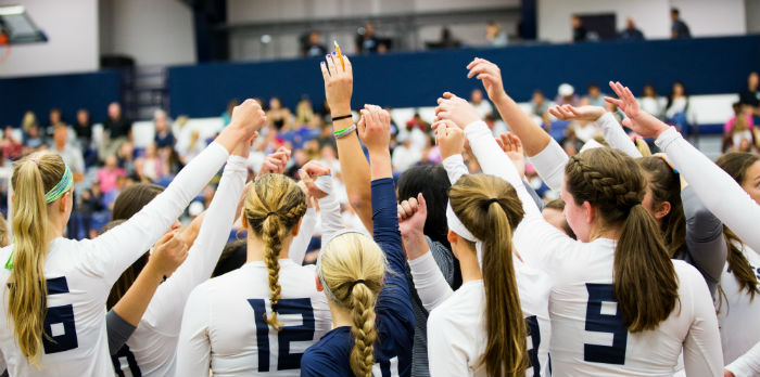 Volleyball players cheering before a game