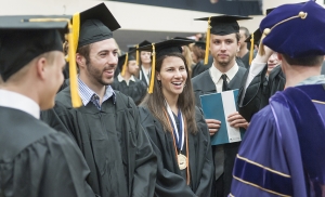 Seniors and master's program graduates meet before the ceremony in Hitchcock Arena to robe and line up for the processional. 