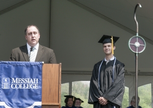 Scott Martin, chair of the alumni council, presents Evan Shirey with the 2015 Donald and Anna Zook Alumni Merit Award