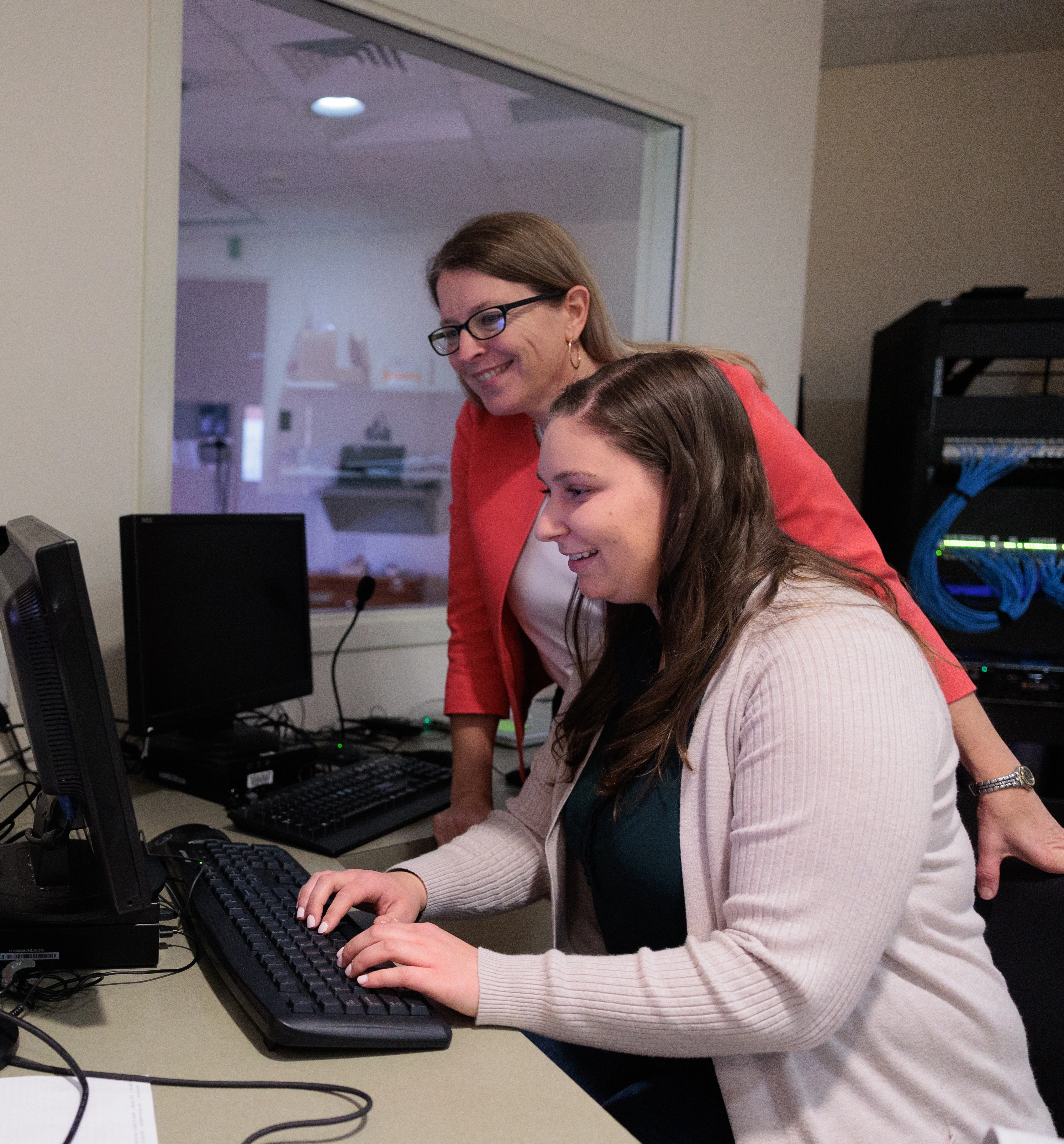 Brenda Elliott instructs a nursing student in the simulation lab