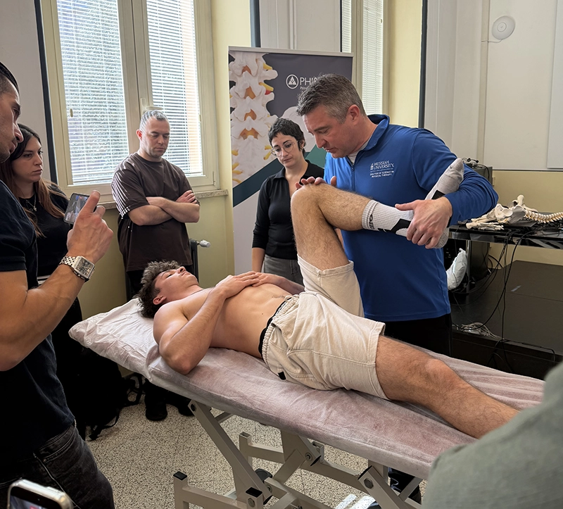 Lehr demonstrates stretching techniques on a patient.