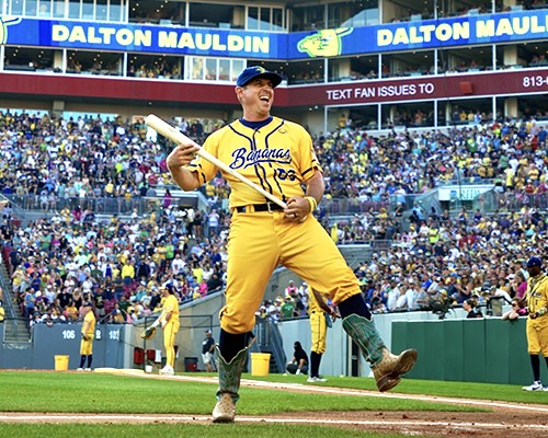 Coach of the bananas in cowboy boots on the baseball field.