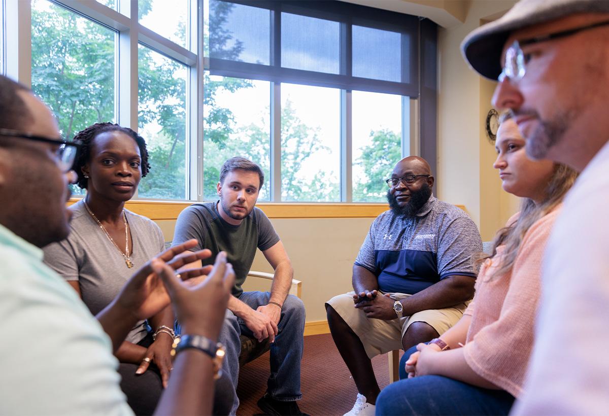 Man counseling group of people.