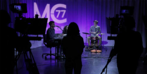 Students behind camera filming MC77 production