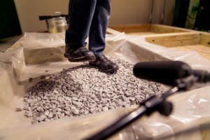 Student steps on rocks to create sound efects