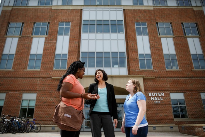Professor Simcox laughing with students