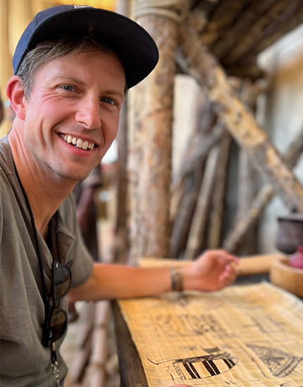 Stephen Procopio smiling with while drawing his artwork for The Chosen.