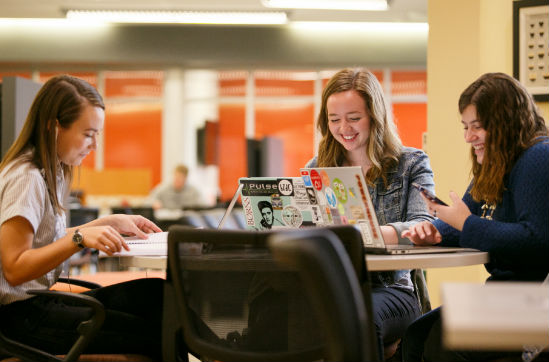 three girls study in the library
