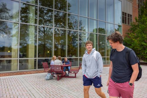 Two male students walking and talking